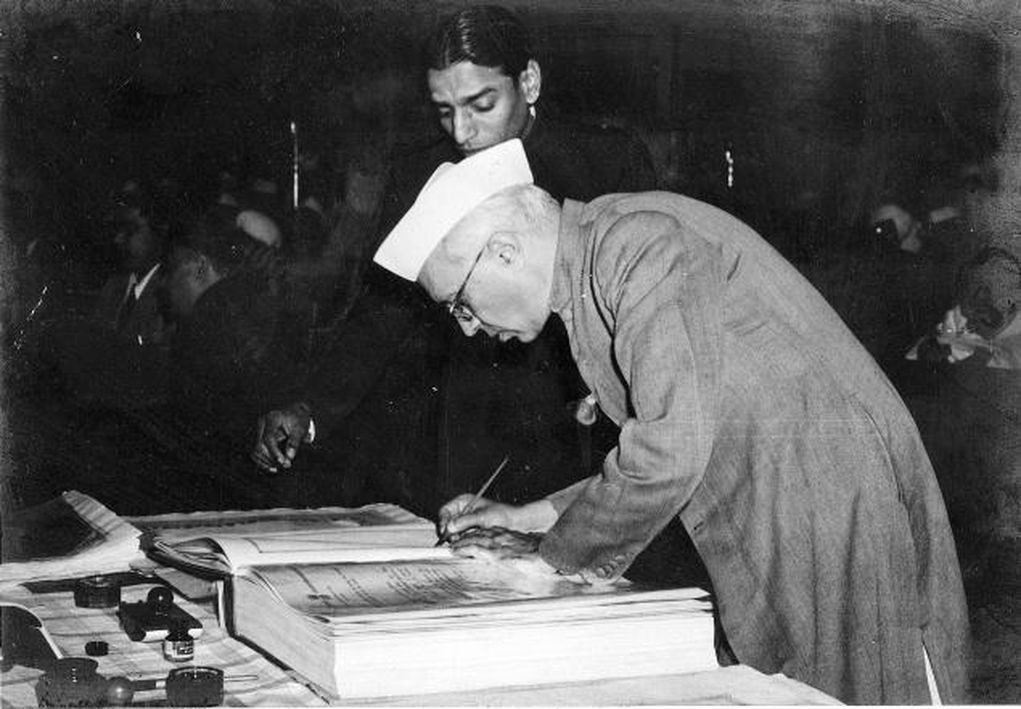 Jawaharlal Nehru signing the constitution